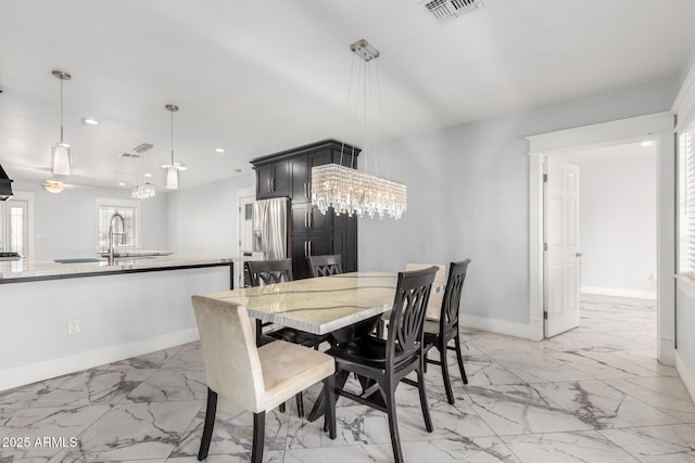 3316 E Fillmore St, Phoenix, AZ 85008 - dining space with light marble finish floors, recessed lighting, and a chandelier