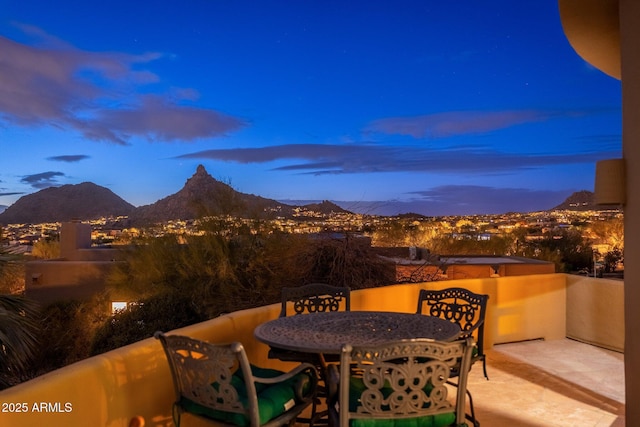 view of patio / terrace with a mountain view, outdoor dining area, and a balcony