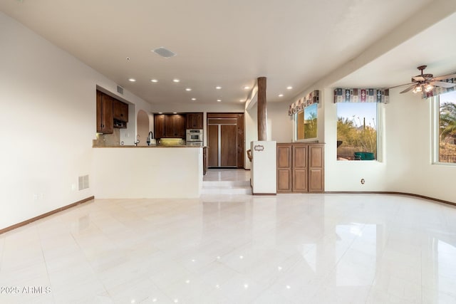 unfurnished living room with visible vents, recessed lighting, a ceiling fan, and baseboards