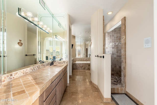 full bath featuring tile patterned flooring, visible vents, baseboards, walk in shower, and vanity