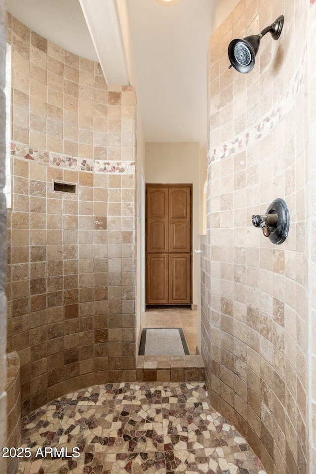 bathroom with tiled shower