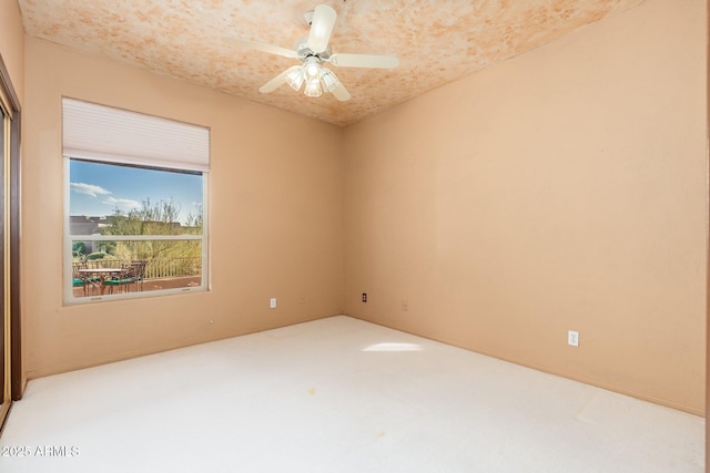 carpeted empty room with ceiling fan