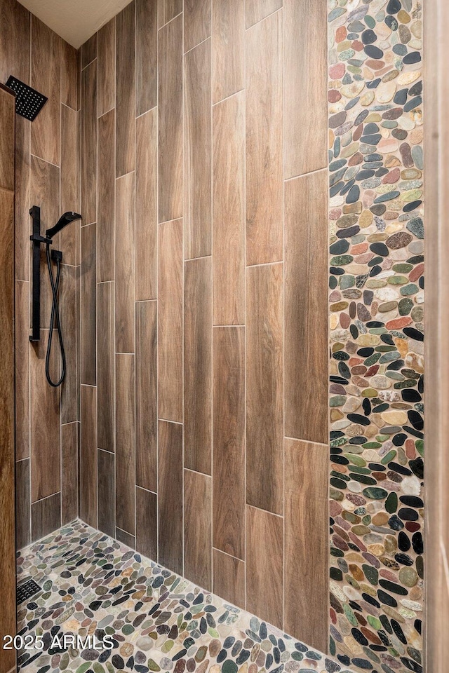 bathroom with a tile shower