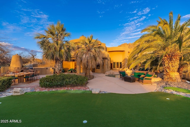 back of house with a yard, area for grilling, an outdoor living space, and a patio