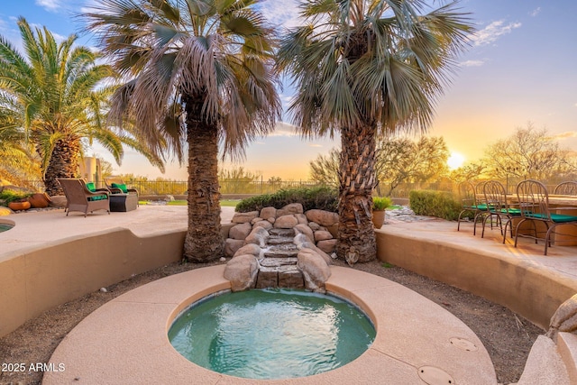 view of swimming pool with a hot tub, outdoor dining area, a patio, and fence