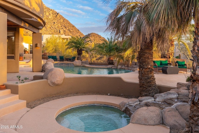 view of swimming pool featuring a fenced in pool, a patio, an in ground hot tub, and an outdoor hangout area