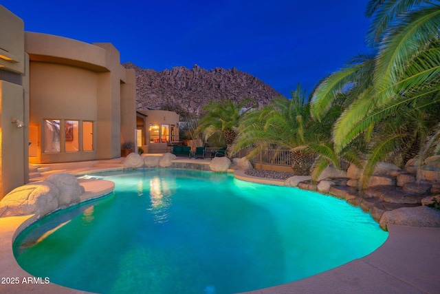 view of pool featuring a fenced in pool, a mountain view, and a patio