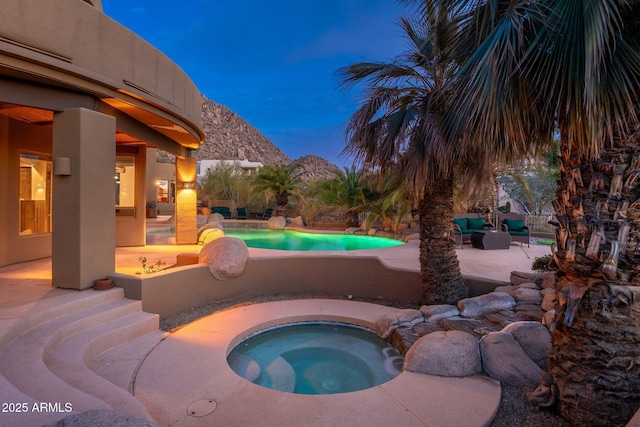 pool featuring a patio and an in ground hot tub