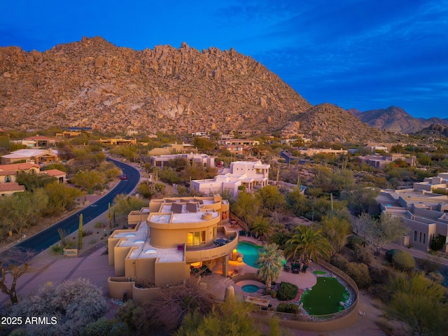 birds eye view of property with a mountain view