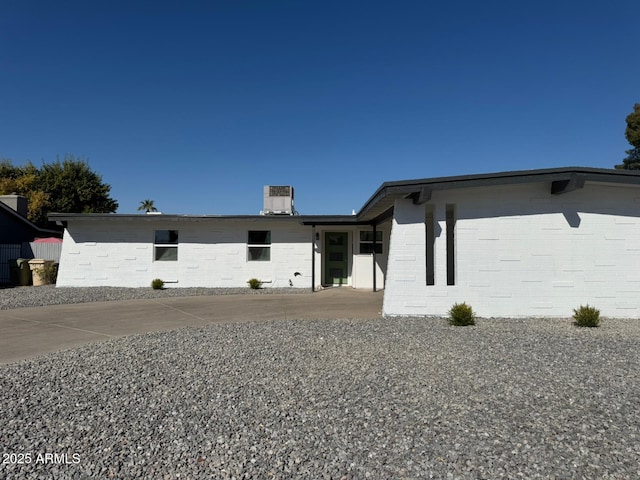 ranch-style home with a patio and central air condition unit