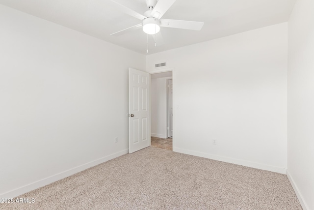 unfurnished room featuring light carpet and ceiling fan