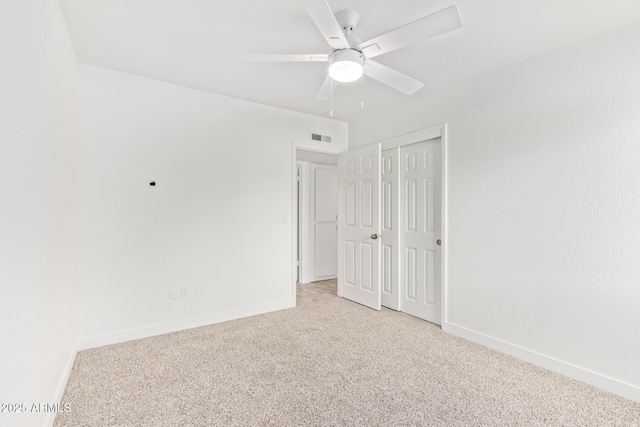 unfurnished room featuring light carpet and ceiling fan