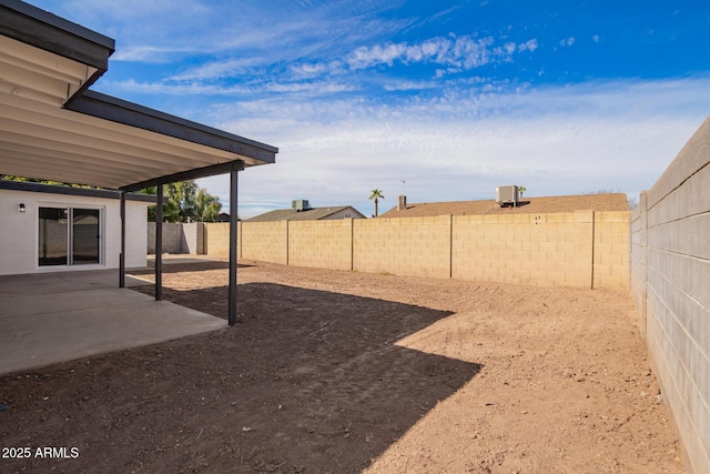 view of yard featuring central AC unit and a patio area