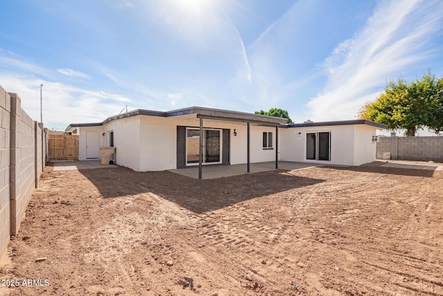 rear view of property featuring a patio area