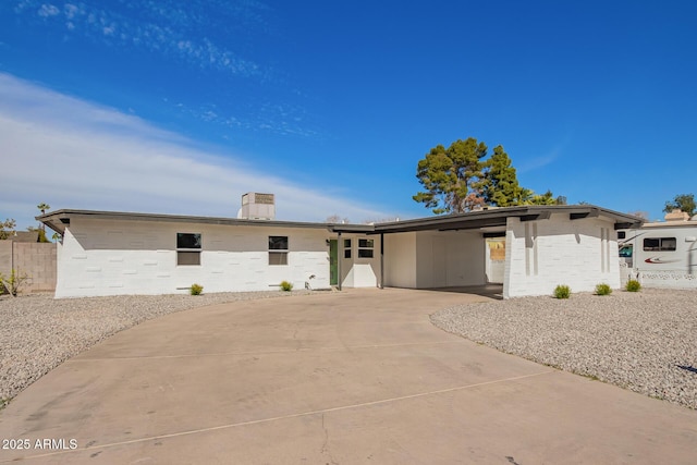 ranch-style house featuring a carport