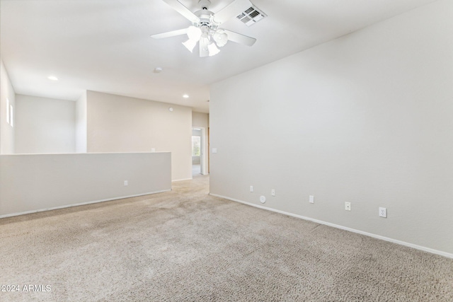 carpeted spare room featuring ceiling fan