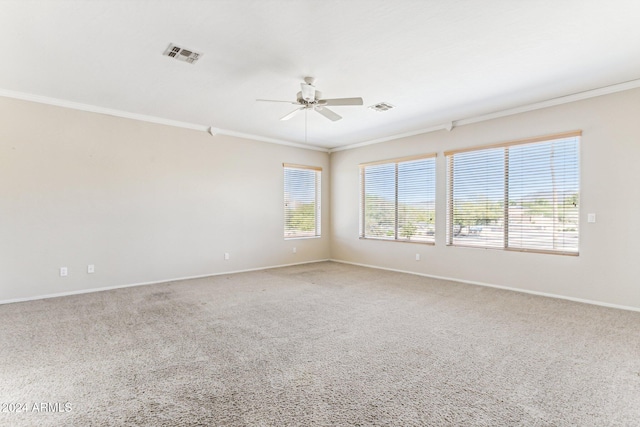 spare room with ceiling fan, ornamental molding, and carpet floors