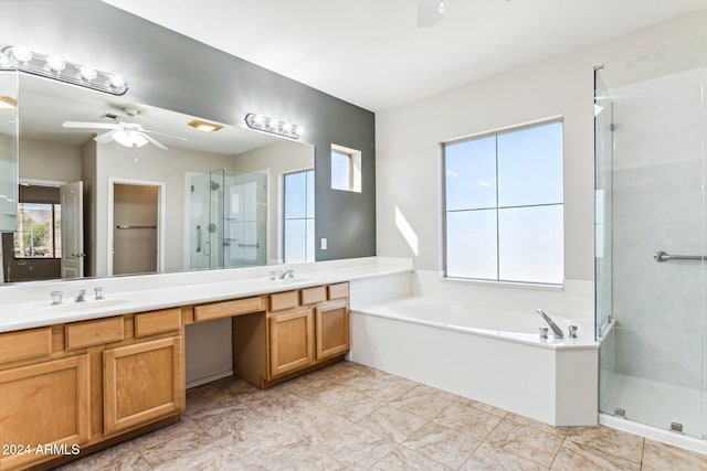 bathroom featuring vanity, a healthy amount of sunlight, separate shower and tub, and ceiling fan