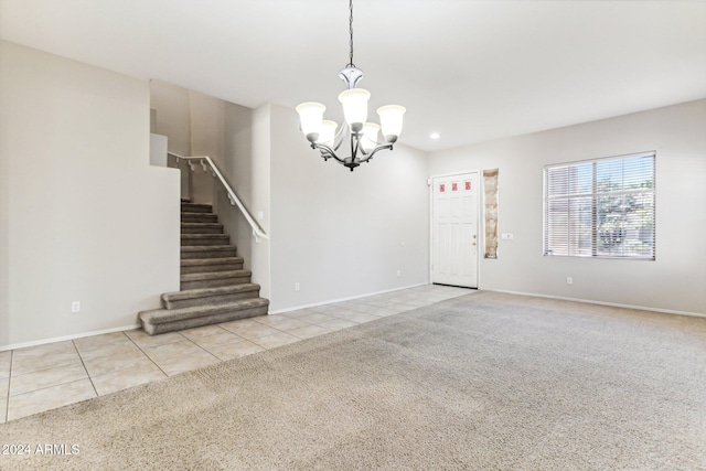 unfurnished living room with a chandelier and light tile patterned floors