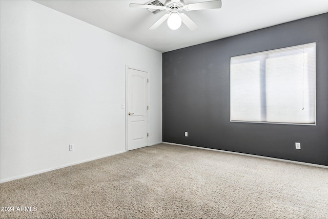 empty room featuring ceiling fan and carpet floors