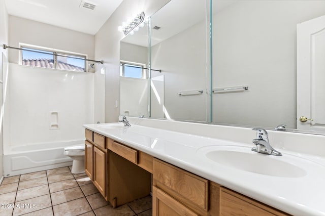 full bathroom with vanity, washtub / shower combination, toilet, and tile patterned floors