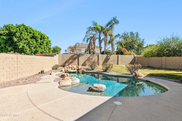 view of pool featuring a lawn