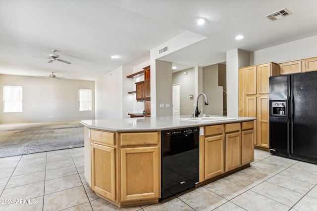 kitchen featuring sink, black appliances, an island with sink, and light colored carpet