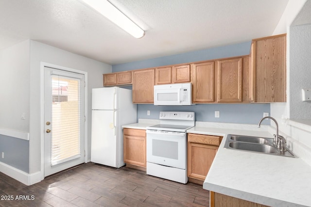 kitchen featuring white appliances, dark wood-style flooring, a sink, light countertops, and a textured ceiling