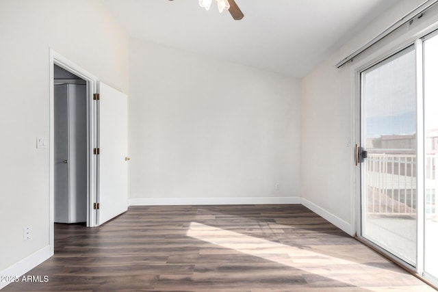 empty room with wood finished floors, a ceiling fan, and baseboards