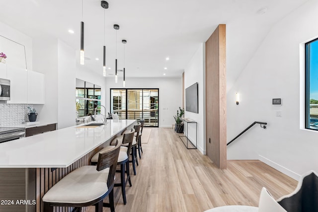 kitchen with light countertops, appliances with stainless steel finishes, a sink, and modern cabinets