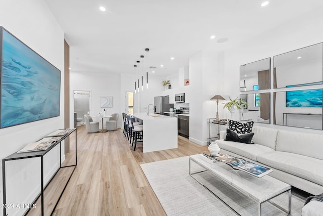 living area featuring recessed lighting and light wood-style flooring