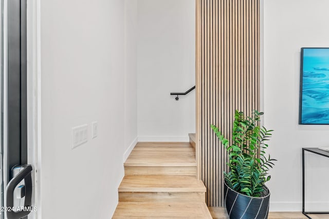 stairs featuring baseboards and wood finished floors