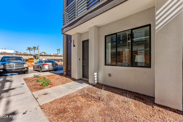 entrance to property with stucco siding