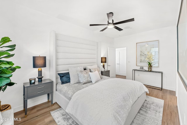 bedroom with baseboards and wood finished floors