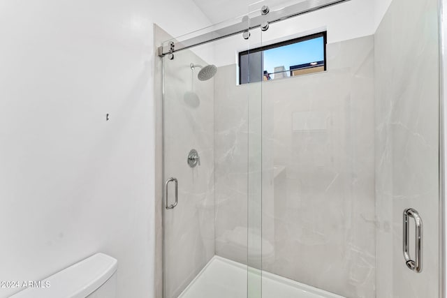 full bath with a stall shower and toilet