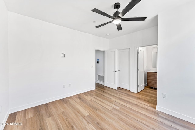 unfurnished bedroom featuring baseboards, light wood finished floors, and visible vents