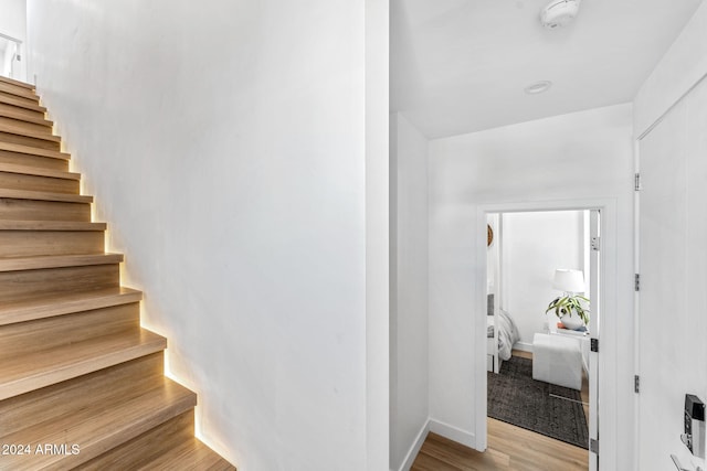 stairway featuring wood finished floors