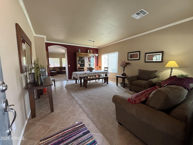 tiled living room with plenty of natural light and crown molding