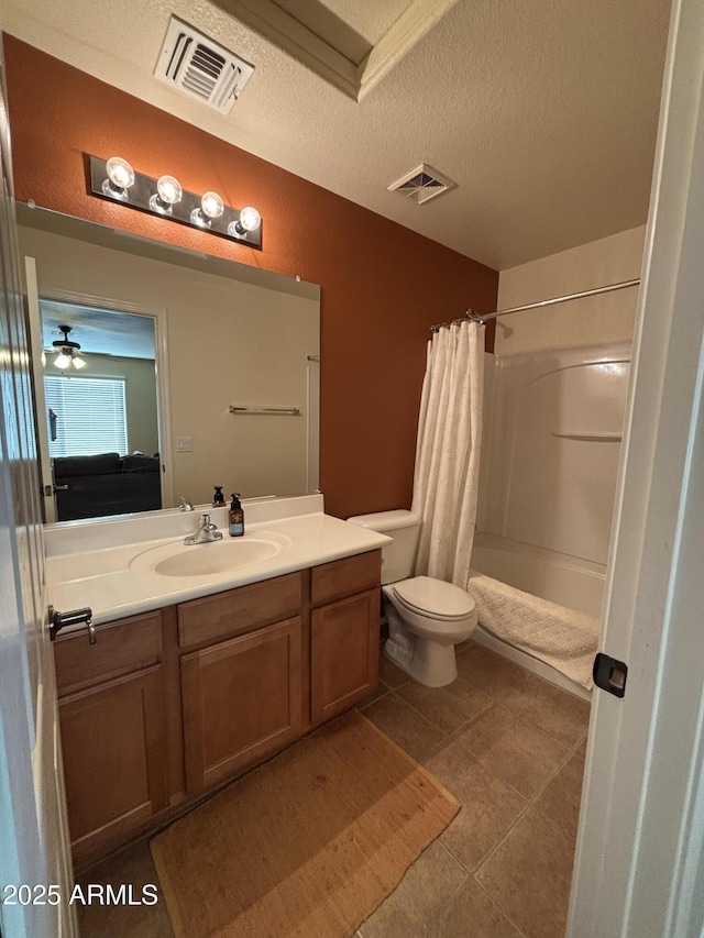 bathroom with toilet, a shower with shower curtain, ceiling fan, a textured ceiling, and vanity