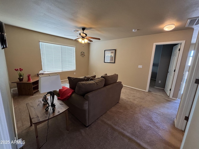 living room featuring a textured ceiling, ceiling fan, and carpet floors