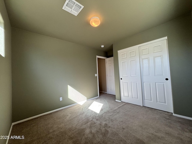 unfurnished bedroom featuring carpet floors and a closet