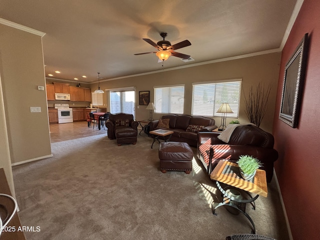 carpeted living room with ceiling fan and crown molding