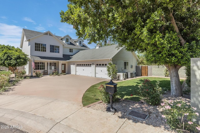 7348 N 9th Pl, Phoenix, AZ 85020 - traditional-style house featuring a garage, concrete driveway, central AC unit, covered porch, and a shingled roof