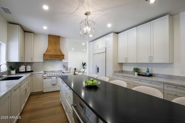 7348 N 9th Pl, Phoenix, AZ 85020 - kitchen featuring high end white range, premium range hood, a sink, a chandelier, and recessed lighting