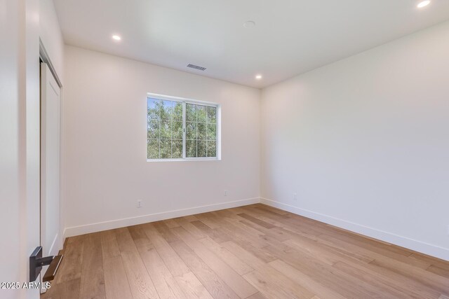 7348 N 9th Pl, Phoenix, AZ 85020 - unfurnished bedroom featuring light wood-style floors, baseboards, and recessed lighting