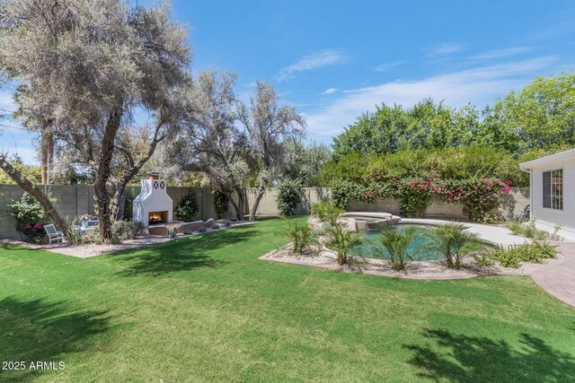 7348 N 9th Pl, Phoenix, AZ 85020 - view of yard with a warm lit fireplace, a pool with connected hot tub, and a patio area