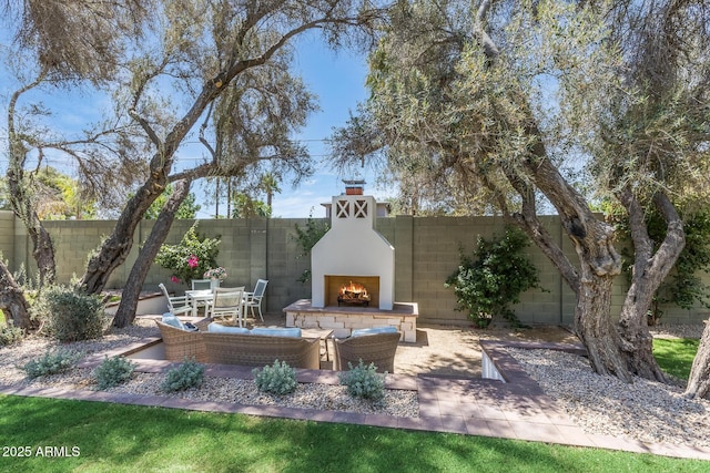 7348 N 9th Pl, Phoenix, AZ 85020 - fenced backyard with a warm lit fireplace and a patio area