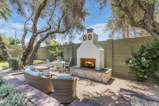 7348 N 9th Pl, Phoenix, AZ 85020 - fenced backyard with a lit fireplace and a patio