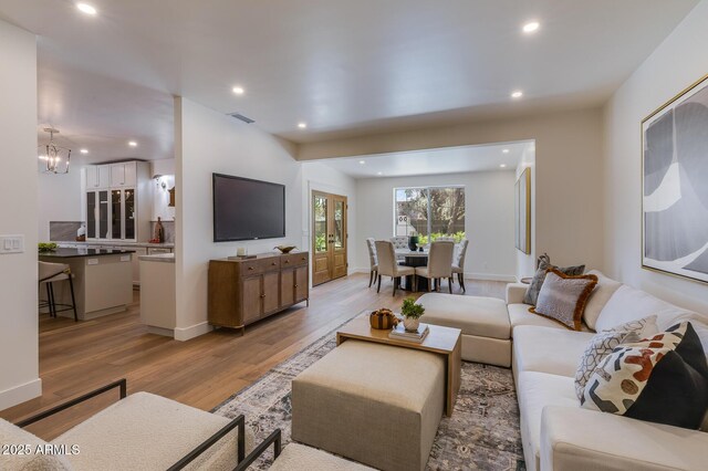 7348 N 9th Pl, Phoenix, AZ 85020 - living room featuring light wood-style floors, recessed lighting, a chandelier, and baseboards