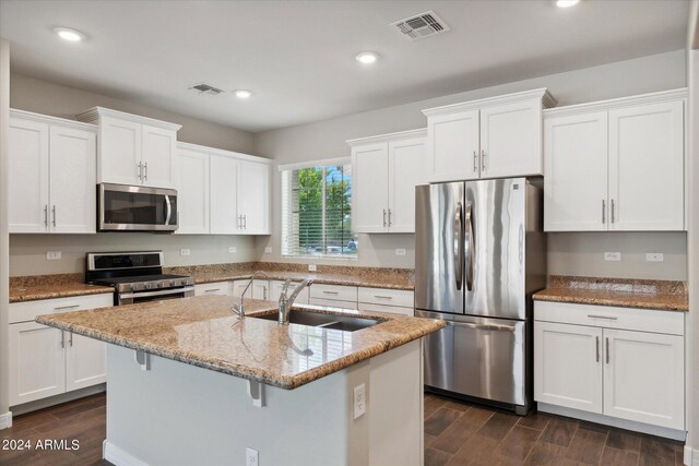 10630 W Pinchot Ave, Avondale, AZ 85392 - kitchen featuring white cabinets, appliances with stainless steel finishes, sink, and a kitchen island with sink